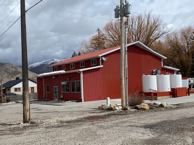 Exterior space featuring an outbuilding, fence, a garage, a mountain view, and a pole building | Image 25