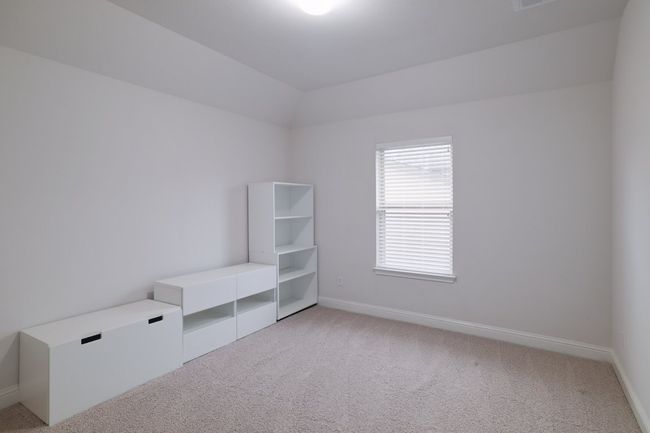 Empty room featuring light carpet, baseboards, and vaulted ceiling | Image 29