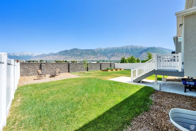 Fenced backyard featuring a mountain view, an outdoor fire pit, and a patio | Image 35