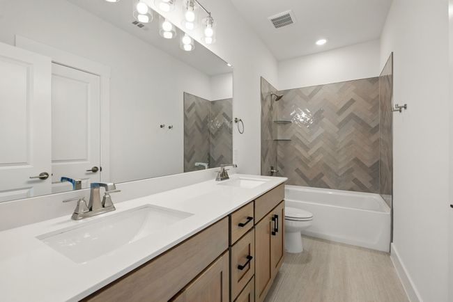 Friends and family will enjoy their own space in this lovely guest bath. | Image 17