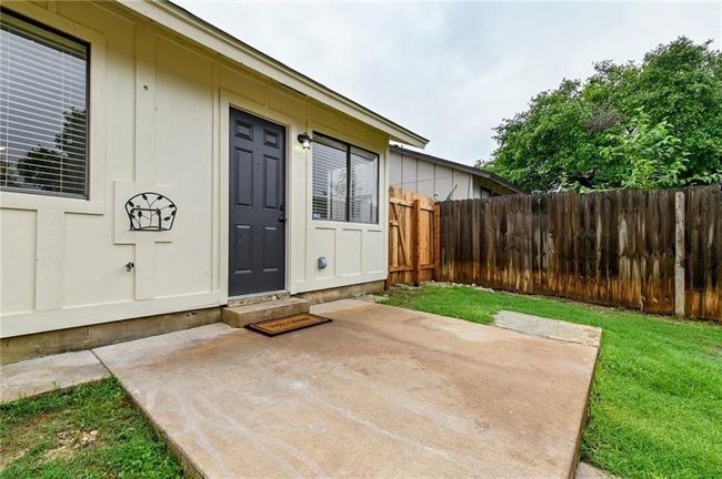 Doorway to property with a patio area and board and batten siding | Image 11