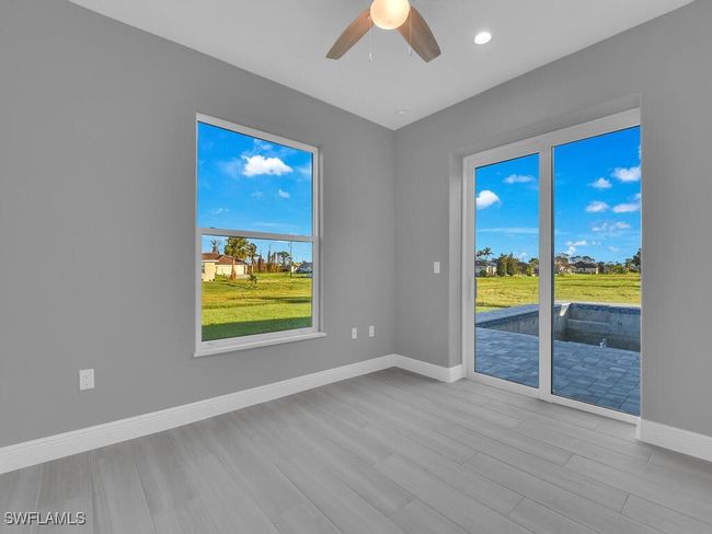 Unfurnished room featuring wood finished floors, ceiling fan, and recessed lighting | Image 28