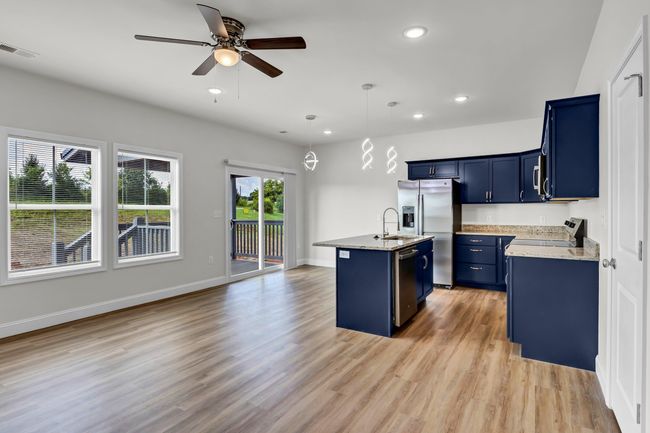 Open concept living, kitchen, and dining rooms. | Image 7