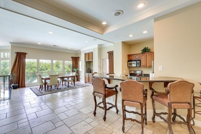 Dining area with crown molding, healthy amount of natural light, recessed lighting, and stone tile floors | Image 30