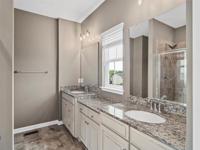 The spacious interior provides a spa-like experience, perfect for relaxing after a long day. Polished fixtures and a clean, modern aesthetic make this shower a standout feature in the bathroom. | Image 18