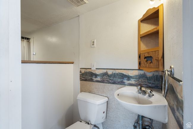 Bathroom with toilet and a sink | Image 18