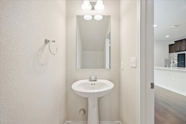 Bathroom featuring visible vents, wood finished floors, a sink, baseboards, and recessed lighting | Image 10