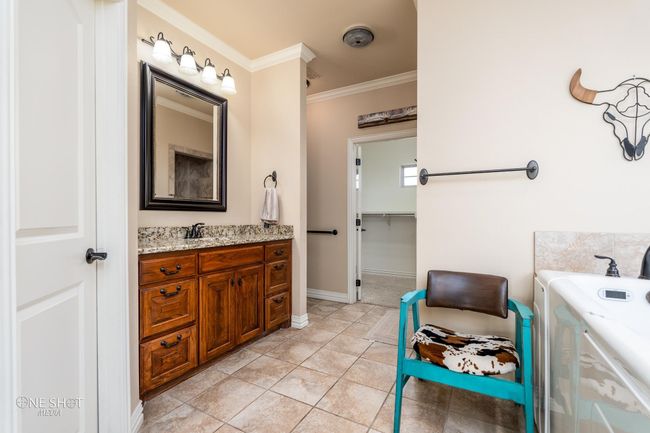 Full bathroom featuring crown molding, vanity, tile patterned floors, and baseboards | Image 22