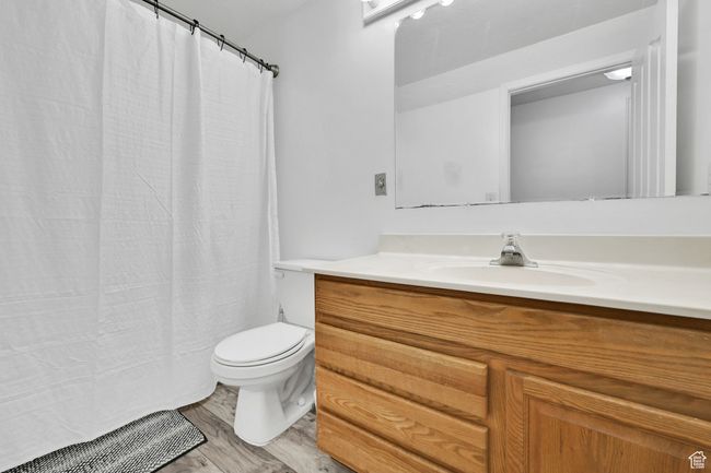 Bathroom with toilet, vanity, and wood finished floors | Image 31