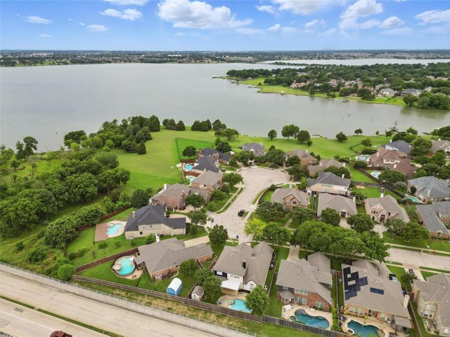 Aerial view of property's location with nearby suburban area and a nearby body of water | Image 38
