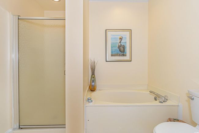 Full bath with toilet, a stall shower, and a garden tub | Image 26