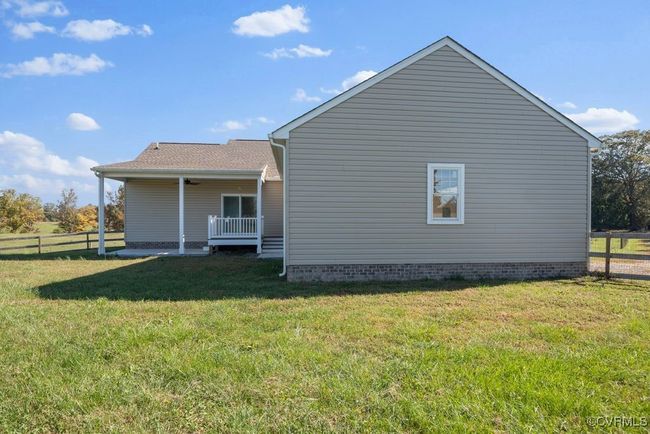 View of side of home featuring fence and a lawn | Image 49
