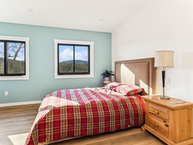 Bright bedroom with high ceilings and rolling mountain views | Image 16