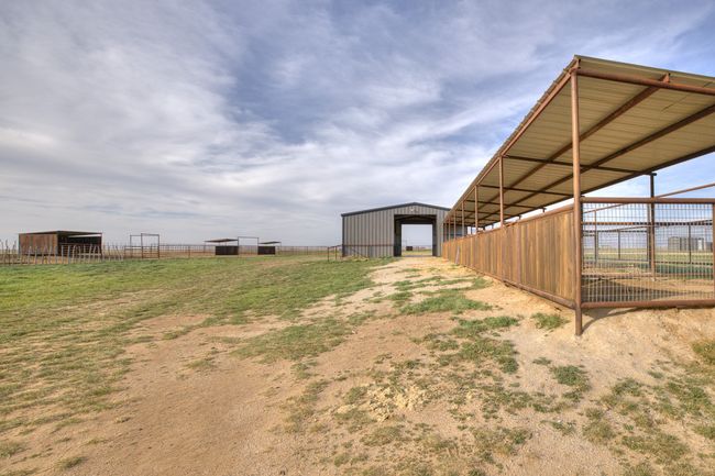 View of yard featuring an outbuilding, an exterior structure, and fence | Image 20