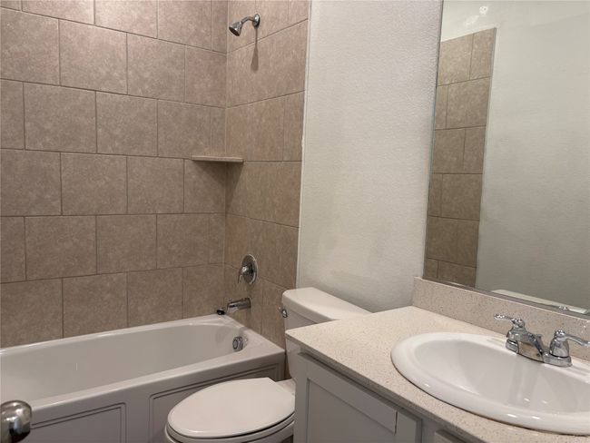 Bathroom featuring toilet, vanity, and shower / bathtub combination | Image 15