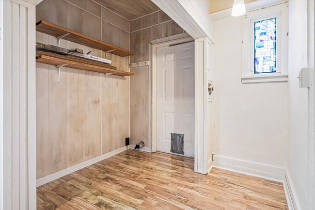 Laundry area featuring light hardwood / wood-style flooring and wood walls | Image 14