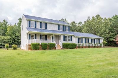 Colonial-style house with a front yard and covered porch | Image 2