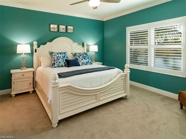 Bedroom featuring ceiling fan, light colored carpet, and ornamental molding | Image 9