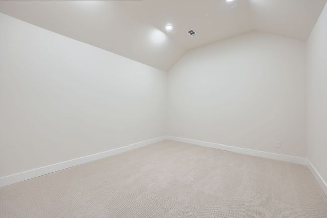 Bonus room featuring light carpet, baseboards, visible vents, and vaulted ceiling | Image 25
