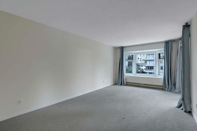 Carpeted spare room with baseboard heating and baseboards | Image 22