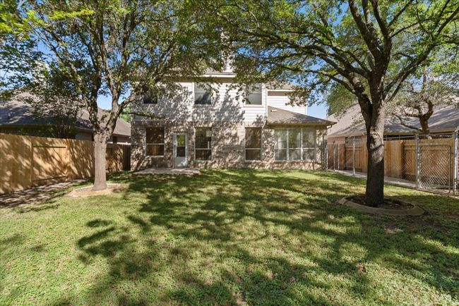 Back of house with a large fenced in backyard and new fencing on multiple sides | Image 33