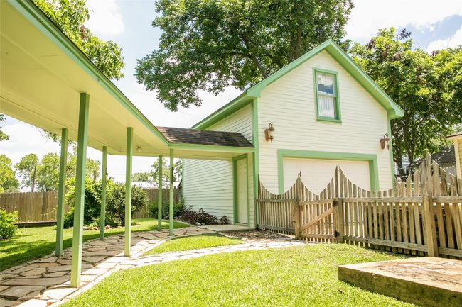 Fenced yard with an attached garage and a gate | Image 6