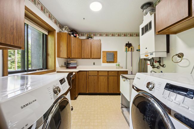 This is the laundry room with plenty of space and cabinets. Through the doorway where this photo was taken is another bath with jetted tub | Image 19