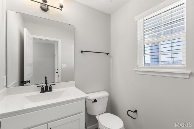 Bathroom featuring toilet and vanity | Image 4