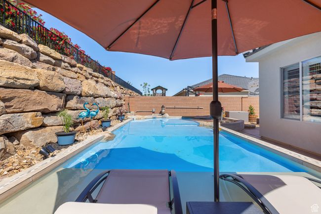 View of pool with a fenced backyard and a pool with connected hot tub | Image 11