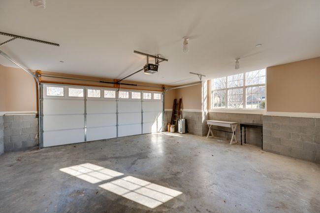 Two car garage with extra space for work bench, sports equipment, or lawn care items. | Image 41