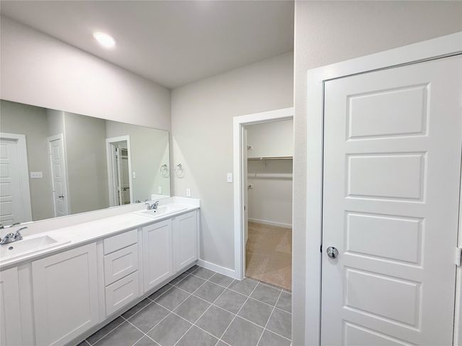 Bathroom featuring double vanity, tile patterned flooring, and a walk in closet | Image 15