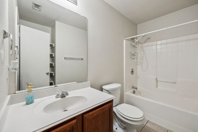 Bathroom featuring shower / washtub combination, vanity, and tile patterned floors | Image 22