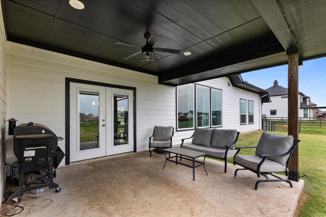View of patio with an outdoor living space, a ceiling fan, french doors, and fence | Image 34