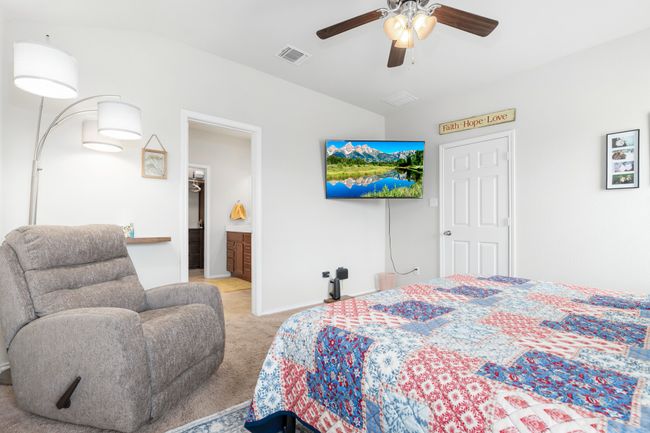 Bedroom with light carpet, baseboards, and a ceiling fan | Image 8