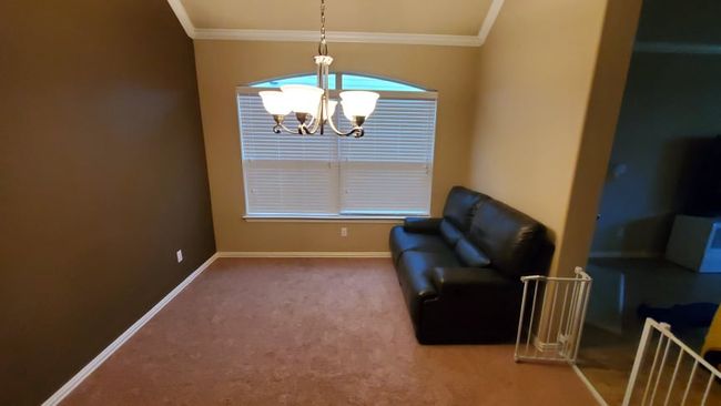 Flex area with ornamental molding, a chandelier, baseboards | Image 6