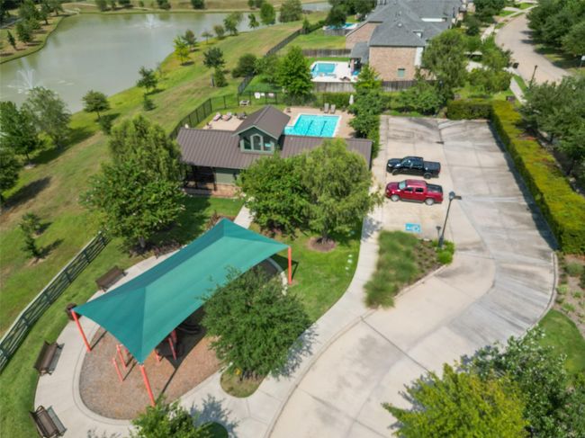 Enjoy a serene, family-friendly community with a refreshing pool, shaded playground, and tranquil pond. Explore tree-lined paths and convenient paved parking. | Image 38