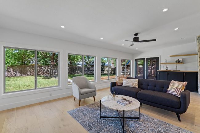 The family room features an entire wall of windows makes the lush backyard feel like an extension of the home. | Image 4