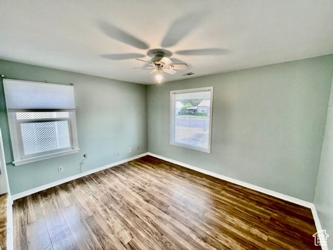 Unfurnished room featuring visible vents, ceiling fan, wood finished floors, and baseboards | Image 7