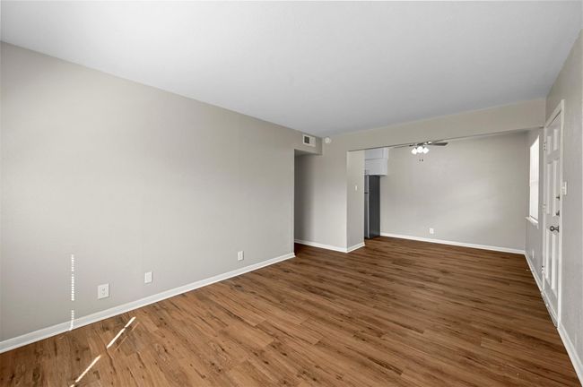 Empty room featuring wood finished floors and a ceiling fan | Image 11