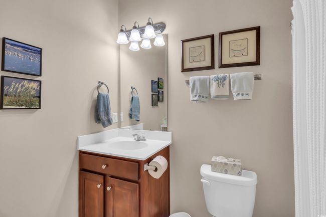 Bathroom featuring toilet and vanity | Image 12