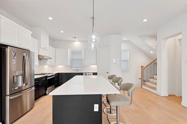 The kitchen island has huge counter space perfect for having a nice cup of coffee in the morning, and for sharing a meal with those in your life. | Image 11