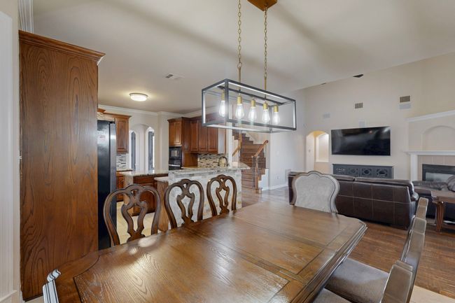 Dining room with visible vents, arched walkways, and stairway | Image 7