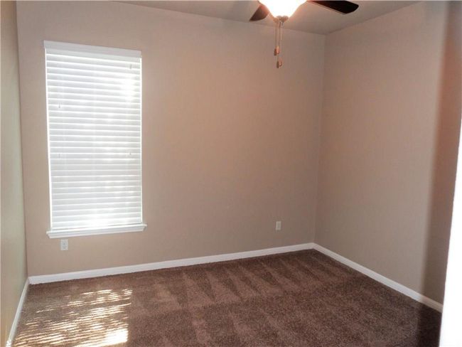 Empty room featuring carpet flooring, ceiling fan, and baseboards | Image 13
