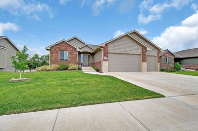 View of front of house featuring a front yard and a garage | Image 1