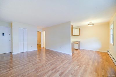 Empty room with a baseboard radiator and light hardwood / wood-style floors | Image 3