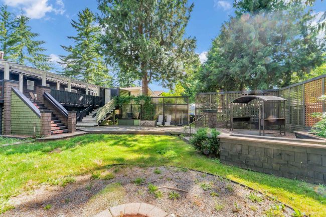 View of yard featuring a wooden deck and stairway | Image 34