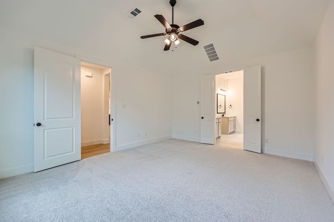 Unfurnished bedroom featuring light carpet, baseboards, and visible vents | Image 13