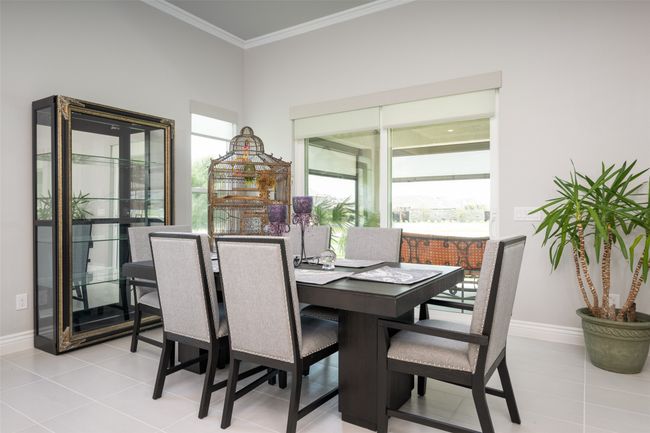 Dining space featuring light tile patterned floors, a wealth of natural light, and crown molding | Image 10