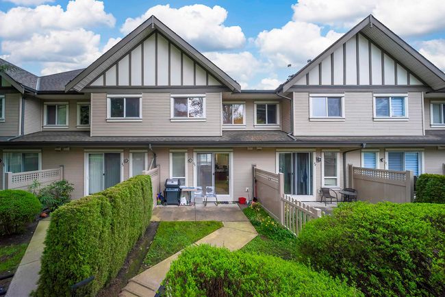Back of property with board and batten siding, a patio area, and fence | Image 15