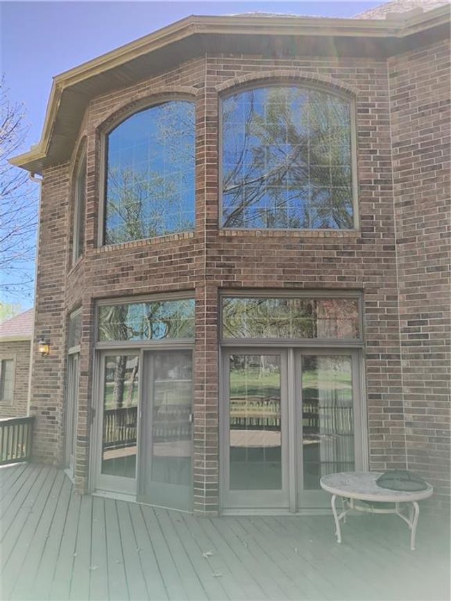 View of exterior entry featuring brick siding and a deck | Image 25